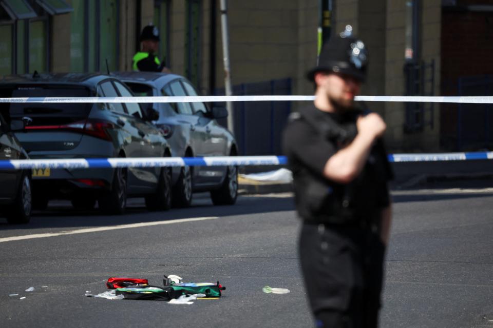 A police officer stands near medical equipment lying on Ilkeston Road following a major incident in Nottingham city centre (Reuters)