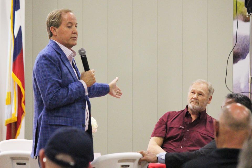 Texas House of Representatives candidate Wade Cowan listens as Attorney General Ken Paxton campaigns for him at an event Wednesday evening at the FiberMax Center for Discovery in Lubbock.