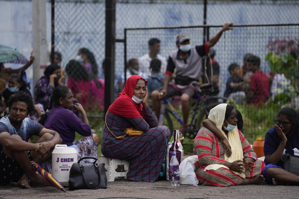 People wait in a fuel station to buy kerosene oil for cooking in Colombo, Sri Lanka, Wednesday, May 18, 2022. Sri Lanka is near bankruptcy having announced that it is suspending upto $ 7 billion foreign loans due to be repaid this year because of a foreign currency crisis. It has led to limited imports with no gasoline in filling stations. Other fuel, cooking gas, medicine and foods are in short supply forcing people to stay in long lines to buy the limited stocks. (AP Photo/Eranga Jayawardena)