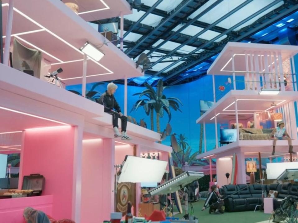 A picture of 2 fake pink houses from Barbie.