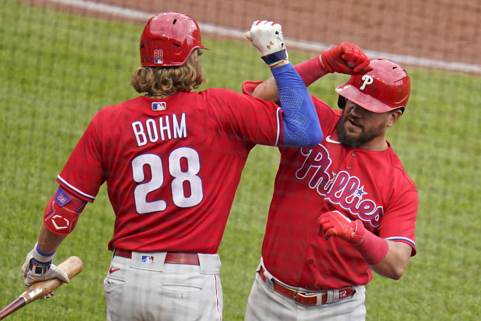 Philadelphia Phillies' Kyle Schwarber, right, celebrates as he returns to the dugout with Alec Bohm after hitting a solo home run off Pittsburgh Pirates starting pitcher JT Brubaker during the fifth inning tof a baseball game in Pittsburgh, Sunday, July 31, 2022. (AP Photo/Gene J. Puskar)