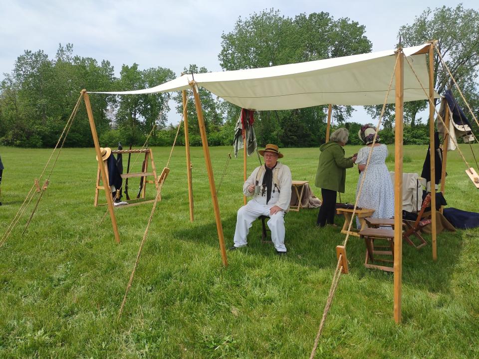 Monroe historian Ralph Naveaux enjoys a beverage in the shade during the Living History event.