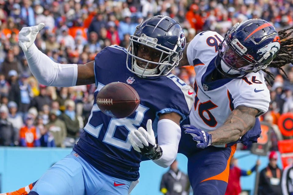 Tennessee Titans safety Joshua Kalu (28) breaks up a pass intended for Denver Broncos wide receiver Tyrie Cleveland (16) during the first half of an NFL football game, Sunday, Nov. 13, 2022, in Nashville, Tenn. (AP Photo/Mark Humphrey)
