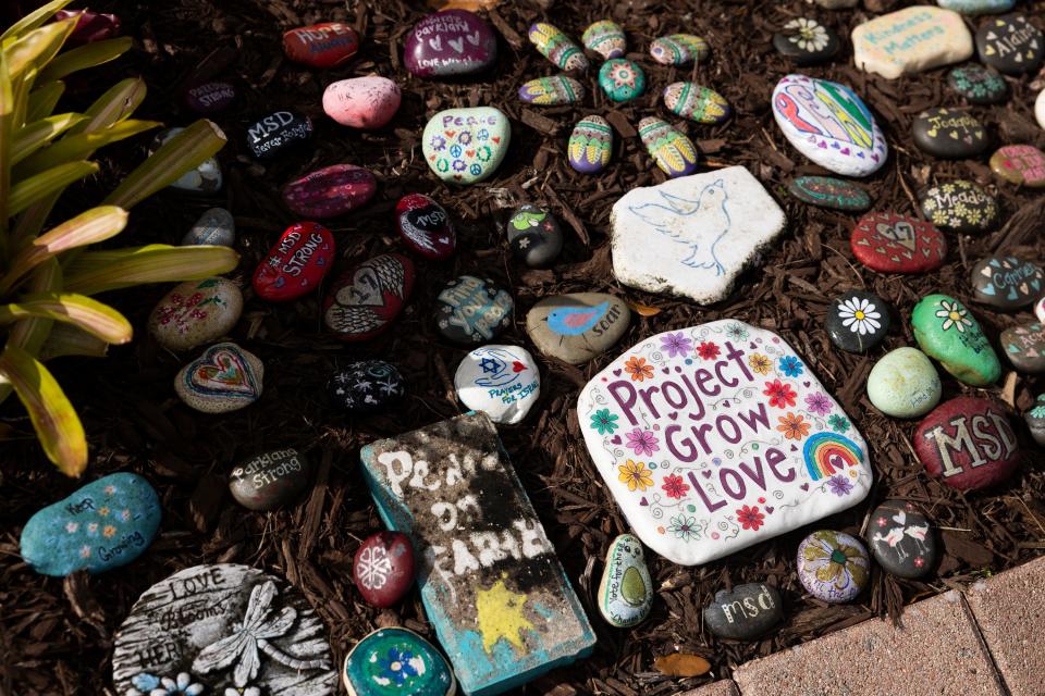 Stones with inspirational messages decorate a memorial garden near Marjory Stoneman Douglas High School on Feb. 10, 2024, in Parkland, Florida.