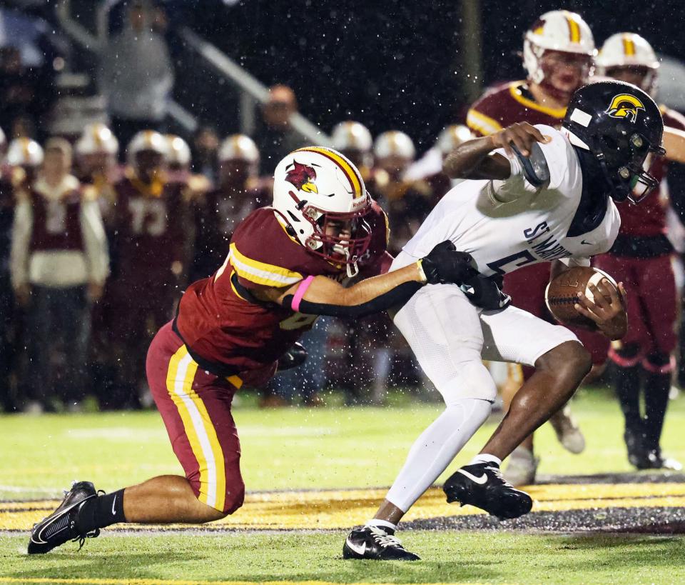 Cardinal Spellman defender MauricIo Gaytan tackles St. Mary's of Lynn Tyler Guy in the back field during a game on Friday, Oct, 20, 2023.