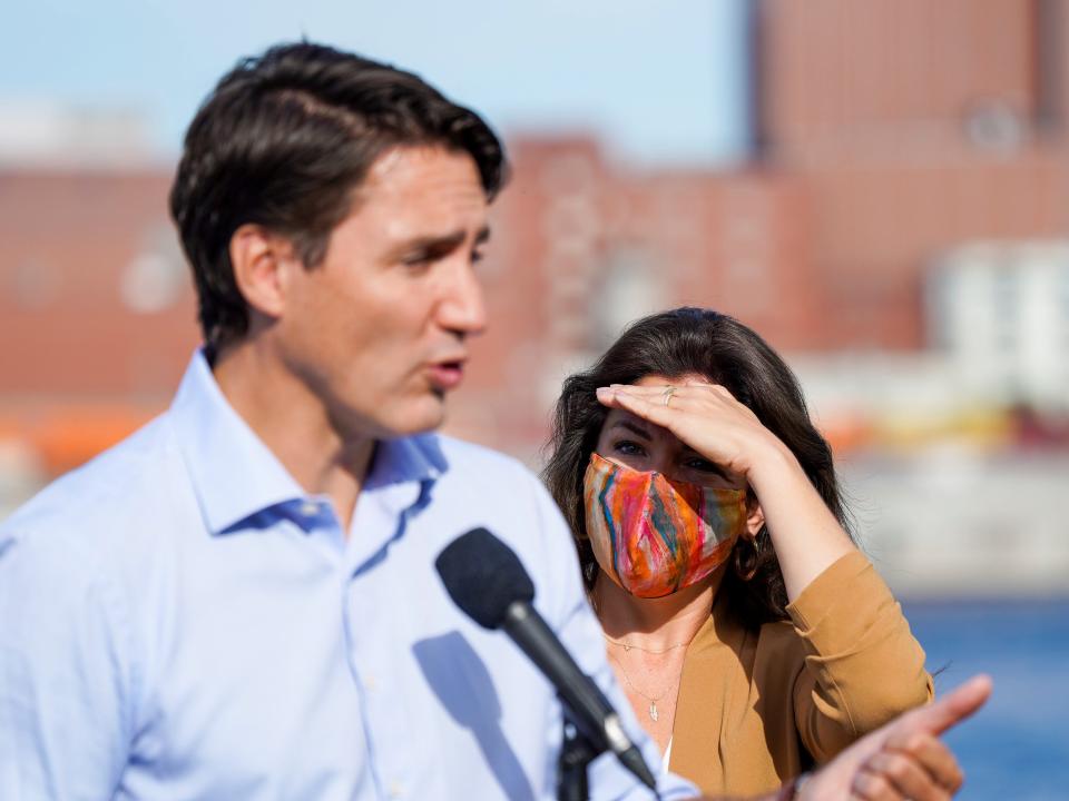 Canada's Liberal Prime Minister Justin Trudeau speaks as his wife Sophie Gregoire Trudeau shields her eyes from the sun during an election campaign stop in Montreal, Quebec, Canada September 16, 2021.