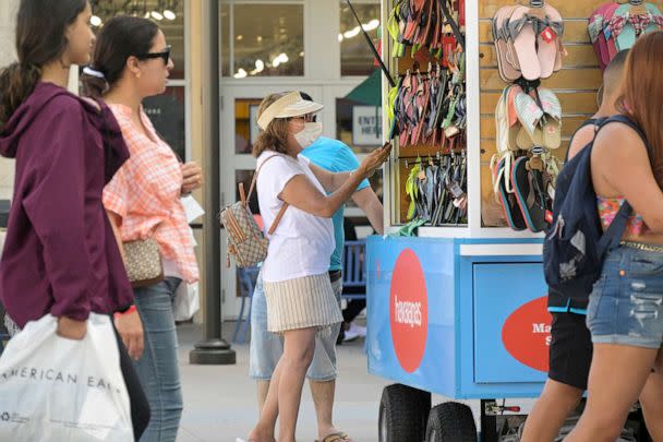 PHOTO: Some people wear face masks while shopping at the Orlando Vineland Premium Outlets shopping mall on July 12, 2022, in Orlando, Fla. (Phelan M. Ebenhack via AP)