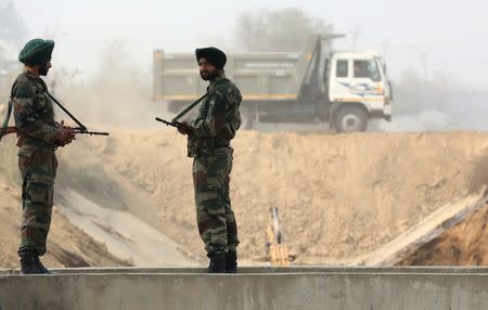 Armed policemen stand guard at the partially damaged Munak canal, that supplies three-fifths of the water to Delhi, in Sonipat in Haryana, India, February 24, 2016. REUTERS/Cathal McNaughton