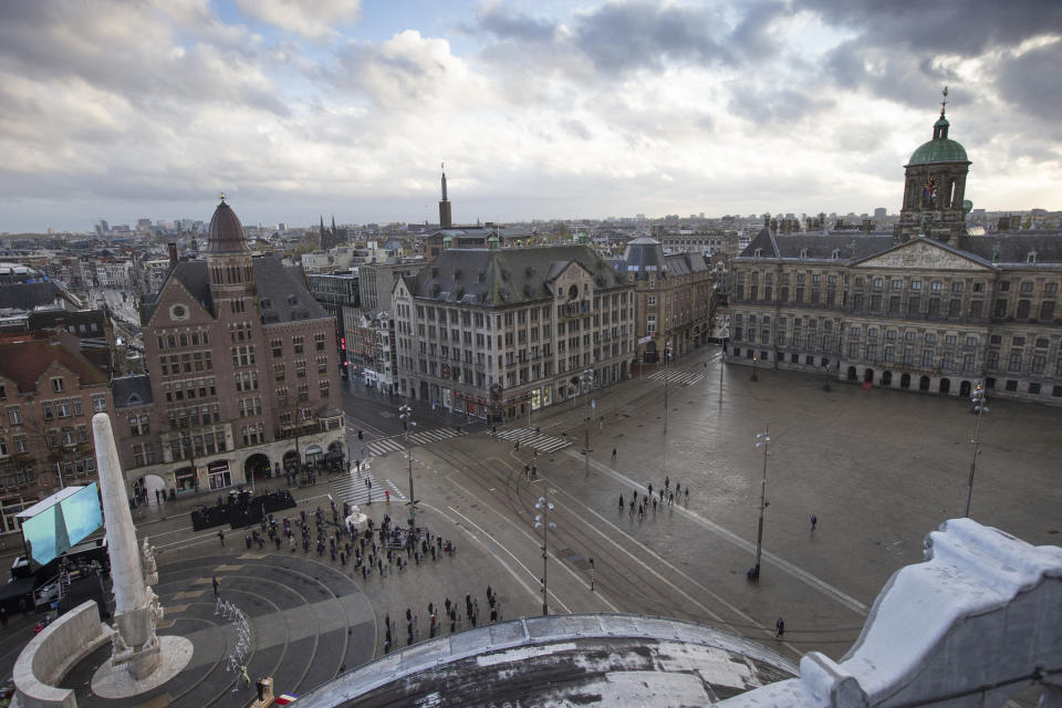 View of Dam Square devoid of spectators due to coronavirus related restrictions, as Dutch King Willem-Alexander and Queen Maxima lay a wreath during a national service to commemorate the war dead in Amsterdam, Netherlands, Tuesday, May 4, 2021. (AP Photo/Peter Dejong, Pool)