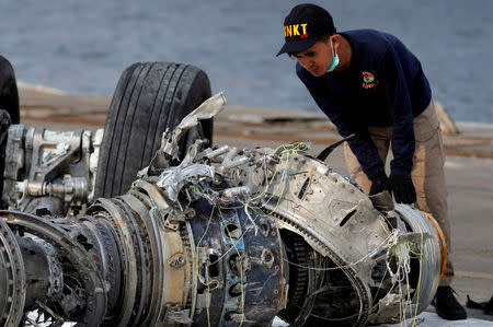 An Indonesian National Transportation Safety Commission (KNKT) official examines a turbine engine from Lion Air flight JT610 at Tanjung Priok port in Jakarta, Indonesia, November 4, 2018. REUTERS/Beawiharta/Files