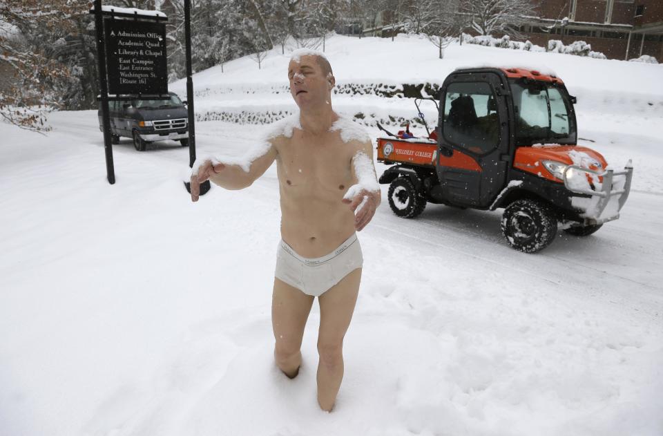 A statue of a man sleepwalking in his underpants is surrounded by snow on the campus of Wellesley College, in Wellesley, Mass., Wednesday, Feb. 5, 2014. The sculpture entitled "Sleepwalker" is part of an exhibit by sculptor Tony Matelli at the college's Davis Museum. (AP Photo/Steven Senne)