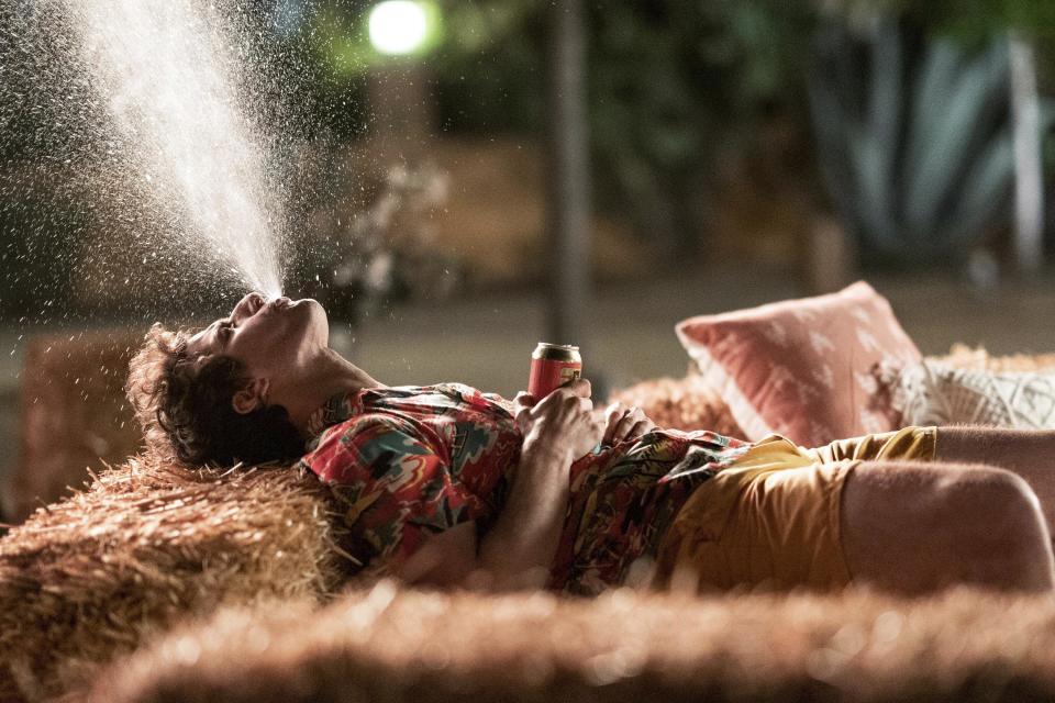 This image released by Hulu shows Andy Samberg in a scene from the film "Palm Springs." (Christopher Willard/Hulu via AP)