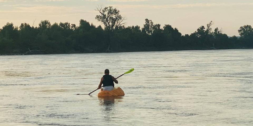 Duane Hansen floats down the Missouri River in a hollowed out pumpkin.