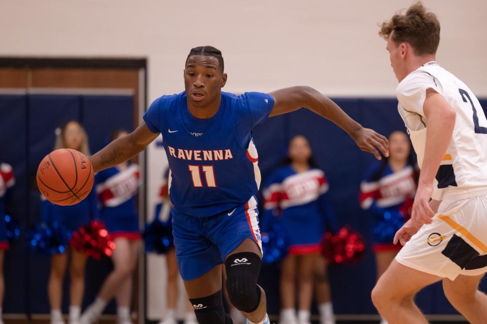 Ravenna senior forward Pavel Henderson runs with the ball during Tuesday night’s basketball game at Streetsboro High School.