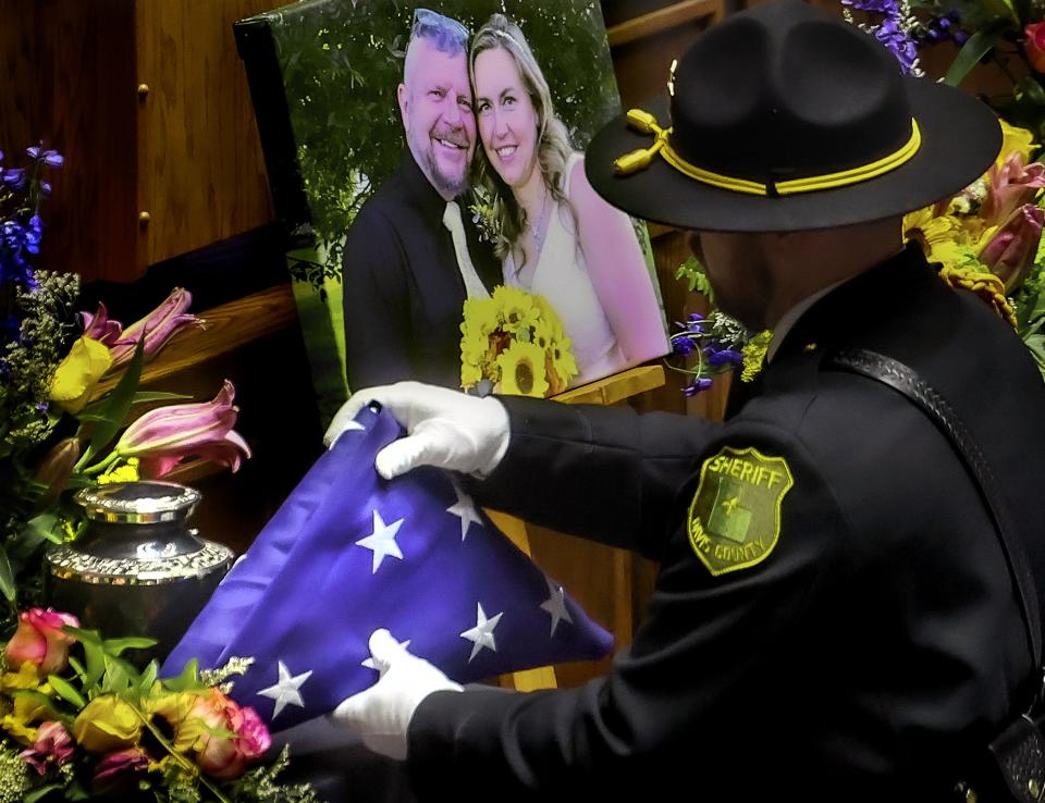 A flag is placed next to an urn during the memorial service for Cpl. Steven Lewis and deputy Jennifer Turner at the Dee Events Center in Ogden on Friday, July 14, 2023. Lewis and Turner were killed in a wrong-way crash near the intersection of South Weber Drive and Canyon Meadows Drive on Monday, July 3. | Laura Seitz, Deseret News