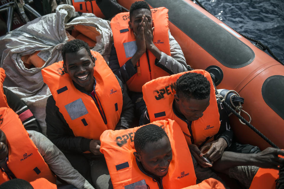 Migrants celebrate on a rescue boat from the Spanish NGO Pro activa Open Arms after being spotted and rescued them at Alboran Sea, about 40 miles (64 kms) from the Spanish coasts, on Thursday, Oct. 11 2018. The Open Arms is now based at Motril port in order to start operating in the western Mediterranean area. (AP Photo/Javier Fergo)