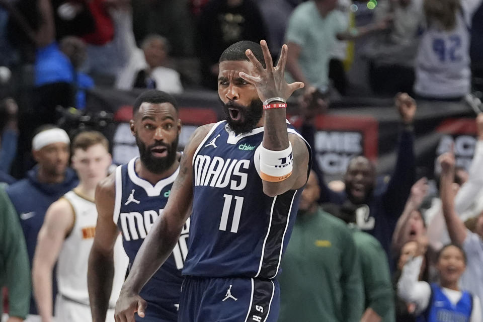 Dallas Mavericks guard Kyrie Irving (11) reacts as teammate Tim Hardaway Jr. runs up after Irving scored the game-winning shot ending the second half of an NBA basketball game against the Denver Nuggets in Dallas, Sunday, March 17, 2024. (AP Photo/LM Otero)