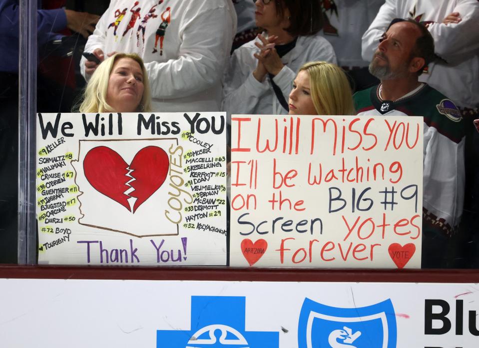 Arizona Coyotes fans in the crowd hold signs for the players following the game against the Edmonton Oilers at Mullett Arena in Tempe on April 17, 2024.