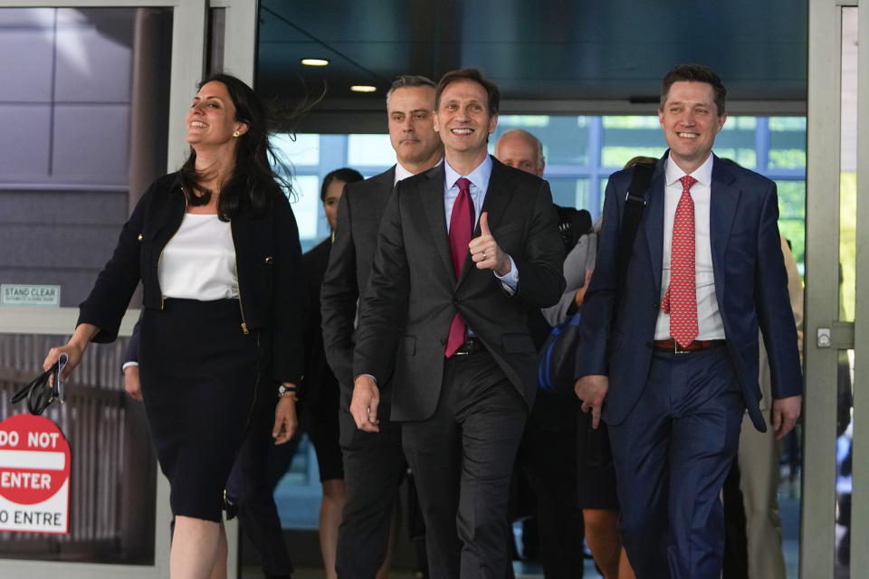 Davida Brook, left, Justin Nelson, center, and Stephen Shackelford, right, attorneys for Dominion Voting Systems, exit the New Castle County Courthouse in Wilmington, Del., after the defamation lawsuit by Dominion Voting Systems against Fox News was settled just as the jury trial was set to begin, Tuesday, April 18, 2023. (AP Photo/Julio Cortez)