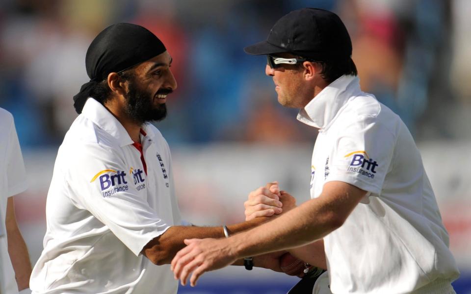 England's Panesar is congratulated by teammate Swann after taking his fifth wicket during the third cricket test match against India in Dubai. - REUTERS