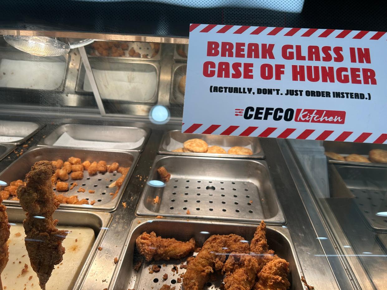 The sign on the glass says it all. People travel to the Cefco Kitchen on Rockwell Road for their chicken fix.