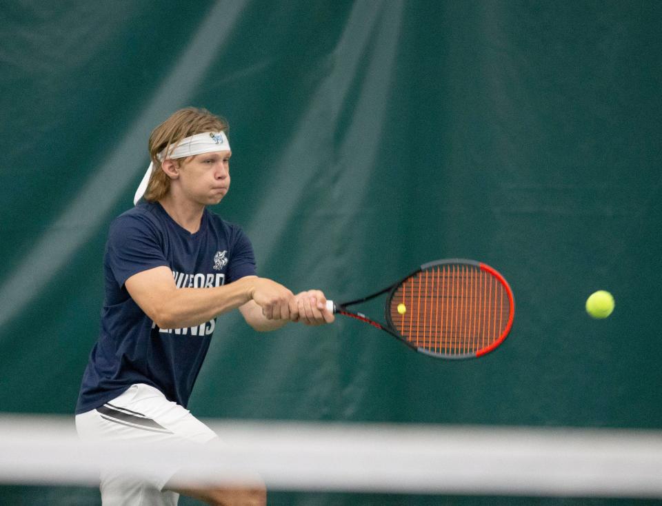 Guilford's Andrew Roberts hits a backhand during the Class 2A Auburn Sectional semifinals Saturday at Boylan Tennis Center.