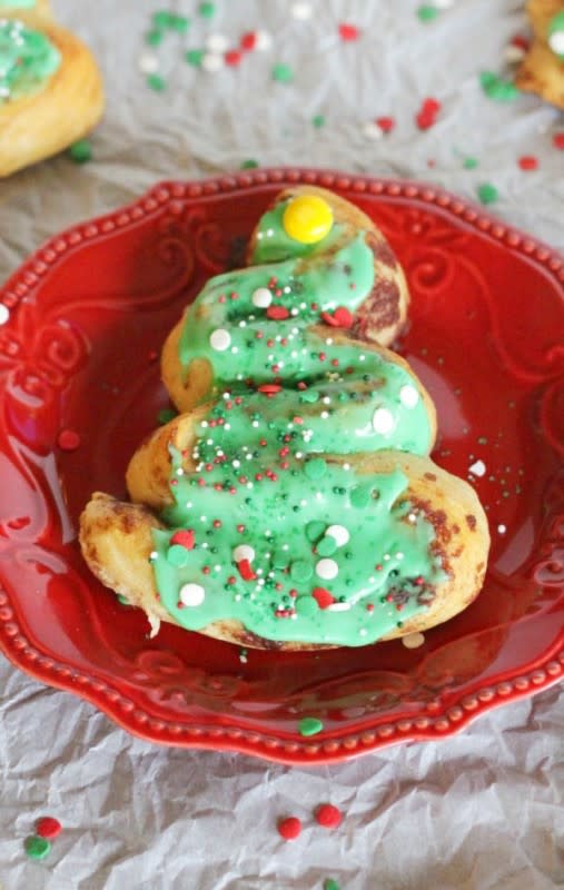 <p>The Pinning Mama</p><p>Make these simple, festive trees for a holiday breakfast using just Pillsbury Grands Cinnamon Rolls, green food coloring and a few M&M’s and sprinkles! </p><p><strong>Get the recipe: <a href="https://www.thepinningmama.com/easy-cinnamon-roll-christmas-trees/" rel="nofollow noopener" target="_blank" data-ylk="slk:Easy Cinnamon Roll Christmas Trees;elm:context_link;itc:0;sec:content-canvas" class="link ">Easy Cinnamon Roll Christmas Trees</a></strong></p>