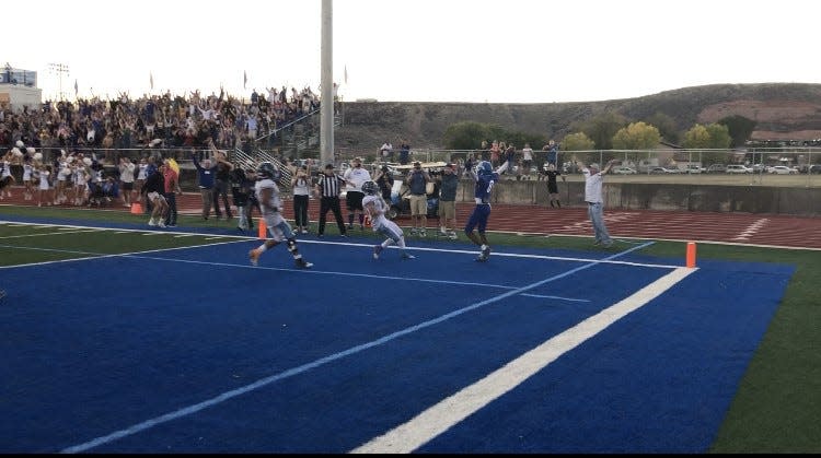 Jahkeo Mitchell throws his arms up in celebration after catching the game-winning two point conversion from Derek Kesterson.