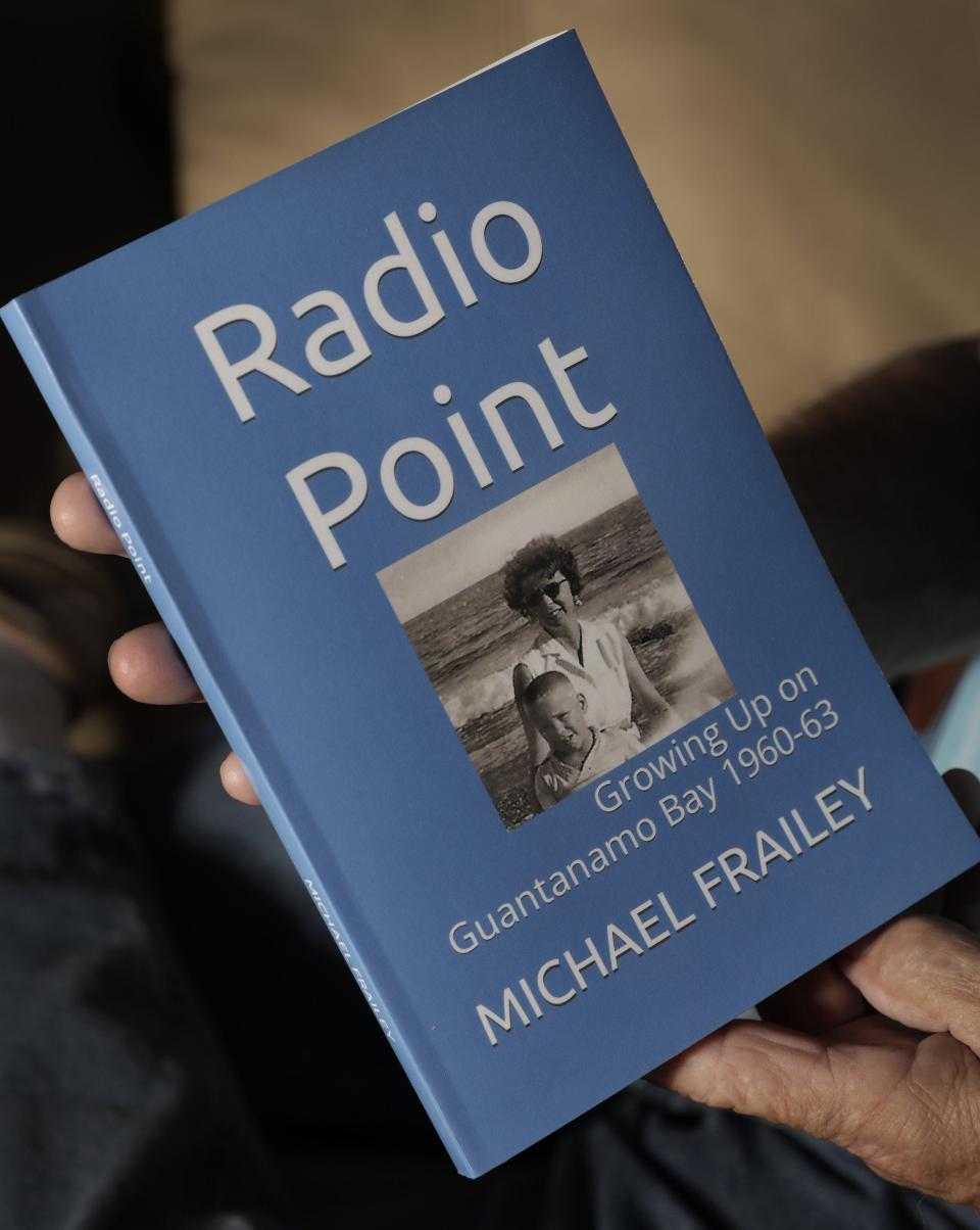 Mike Frailey with a copy of his self-published book about his memories of growing up on the naval base at Guantanamo Bay, Cuba.