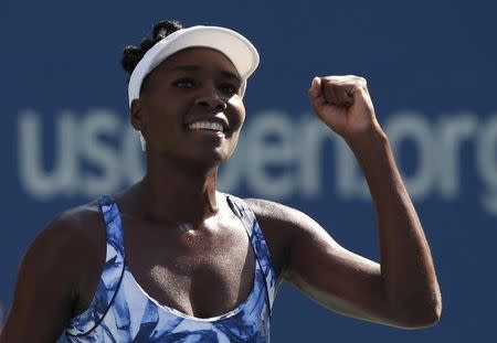 Venus Williams of the U.S. reacts after defeating Kimiko Date-Krumm of Japan during their match at the 2014 U.S. Open tennis tournament in New York, August 25, 2014. REUTERS/Mike Segar