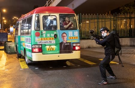 A woman reacts as a police officer uses a weapon against demonstrators during a protest in Hong Kong