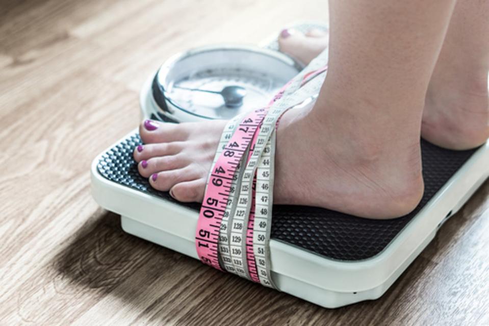 <span class="caption">Weighing oneself often becomes a trap for those with eating disorders.</span> <span class="attribution"><a class="link " href="https://www.shutterstock.com/image-photo/feet-tied-measuring-tape-weight-scale-668247181?src=DNymoX69upd5ZTL3kiSrpw-1-1" rel="nofollow noopener" target="_blank" data-ylk="slk:Tero Vesalainen/Shutterstock.com;elm:context_link;itc:0;sec:content-canvas">Tero Vesalainen/Shutterstock.com</a></span>