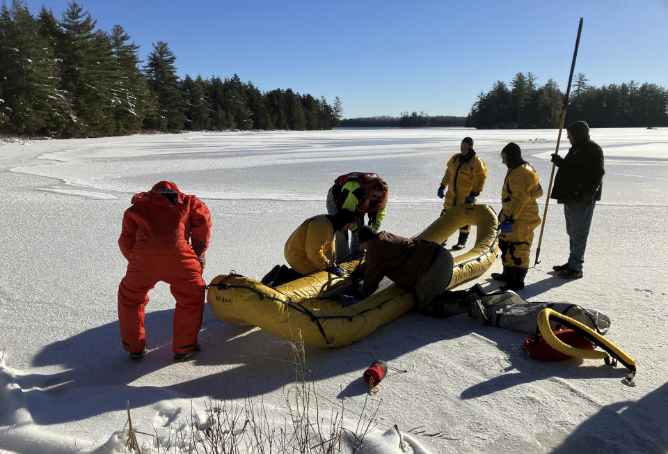 In this photo provided by the Maine Warden Service, rescuers work with an ice rescue raft on a lake in the Maine wilderness where a man crashed into the icy water and drowned, Friday, Dec. 8, 2023, in T3 Indian Township Purchase, Maine. (Maine Warden Service via AP)