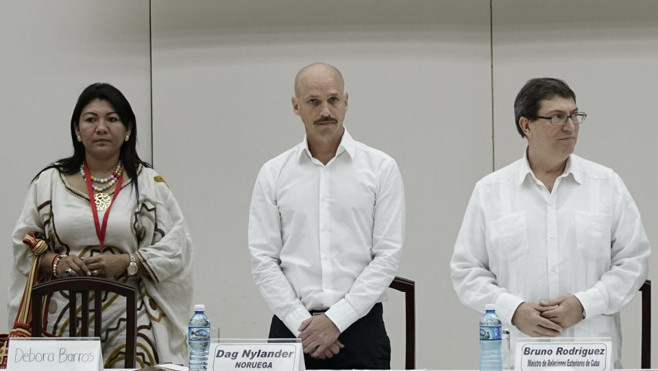 In this Dec. 15, 2015 photo, Norwegian diplomat Dag Nylander, flanked by Colombian activist leader Debora Barros and Cuba's Foreign Minister Bruno Rodriguez, stands during a meeting related to the peace talks between the Colombian government and the FARC, at Convention Palace in Havana, Cuba. Nylander is leading the exploratory talks between representatives of Nicolas Maduro and his opponents whose second round wrapped up Wednesday, May 29, 2019, in Norway. (AP Photo/Ramon Espinosa)