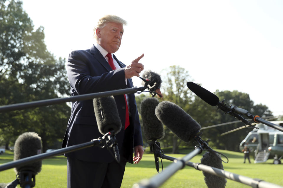 President Donald Trump talks to the press before walking across the South Lawn of the White House, in Washington, Wednesday, Aug. 7, 2019, to board Marine One for a short trip to Andrews Air Force Base, Md., and then on to Dayton, Ohio, and El Paso, Texas, in the afternoon to praise first responders and console family members and survivors from two recent mass shootings. (AP Photo/Andrew Harnik)