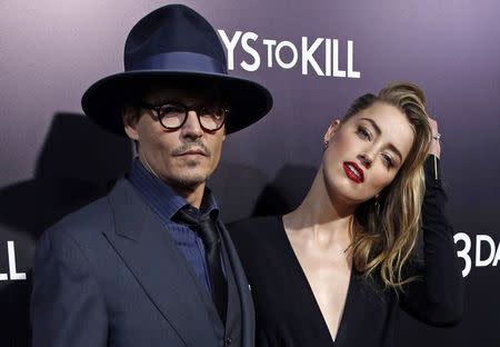 Cast member Amber Heard and her fiance, actor Johnny Depp, pose at the premiere of "3 Days to Kill" in Los Angeles, California, in this file photo taken February 12, 2014. REUTERS/Mario Anzuoni/Files