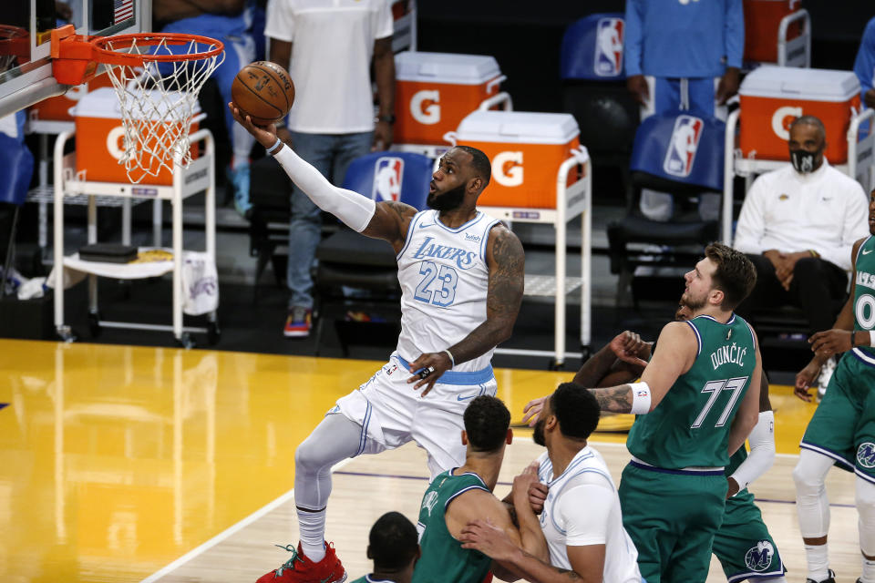 Los Angeles Lakers' LeBron James (23) goes up for a layup against the Dallas Mavericks during the first half of an NBA basketball game Friday, Dec. 25, 2020, in Los Angeles. (AP Photo/Ringo H.W. Chiu)