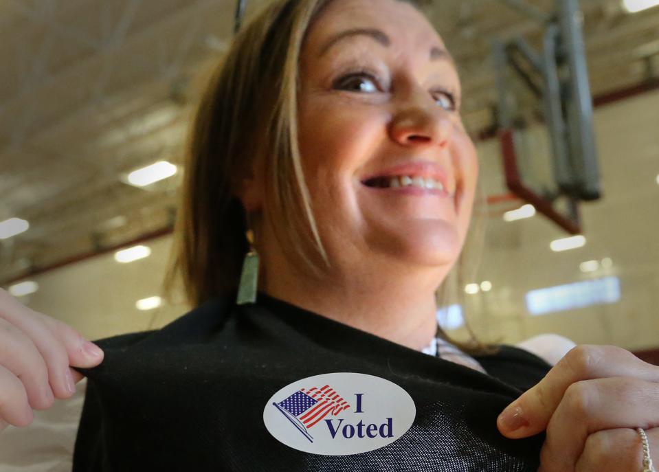 Portsmouth resident Lori Waltz shows off her "I Voted" sticker after casting her ballot at Ward 2 at the city middle school Tuesday, Nov. 8, 2022.