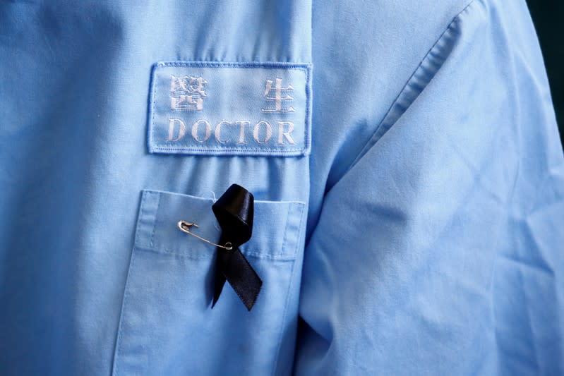 FILE PHOTO: A doctor wears a protest ribbon during a picket by medical staff denouncing what they say is police brutality during recent anti-government protests, at Queen Elizabeth Hospital in Hong Kong, China