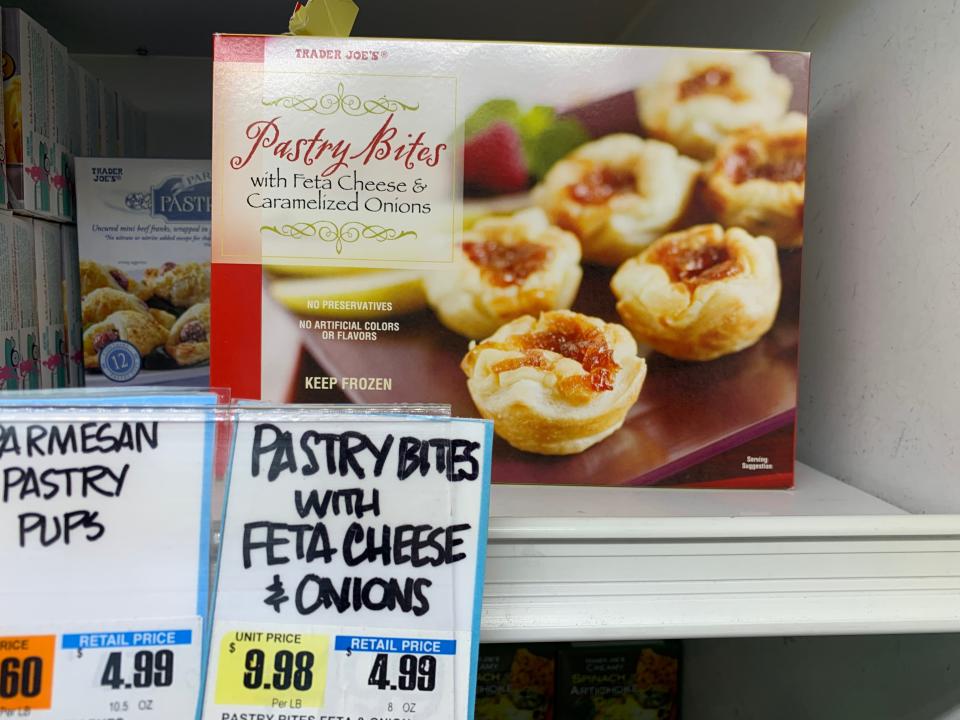 Package of pastry bites with feta and caramelized onions at trader joe' s