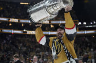 FILE - Vegas Golden Knights right wing Mark Stone (61) skates with the Stanley Cup after the Knights defeated the Florida Panthers 9-3 in Game 5 of the NHL hockey Stanley Cup Finals Tuesday, June 13, 2023, in Las Vegas. The Knights won the series 4-1. The Vegas Golden Knights head into the season as the NHL's defending champions. But a host of stacked challengers await once the season begins. (AP Photo/John Locher, File)