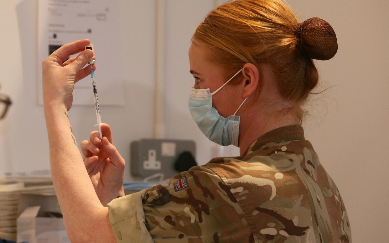 Lance corporal (LCpl) Amy Portman loads an injection of a coronavirus vaccine whilst assisting with the vaccination programme at the Royal Highland Showground near Edinburgh - PA