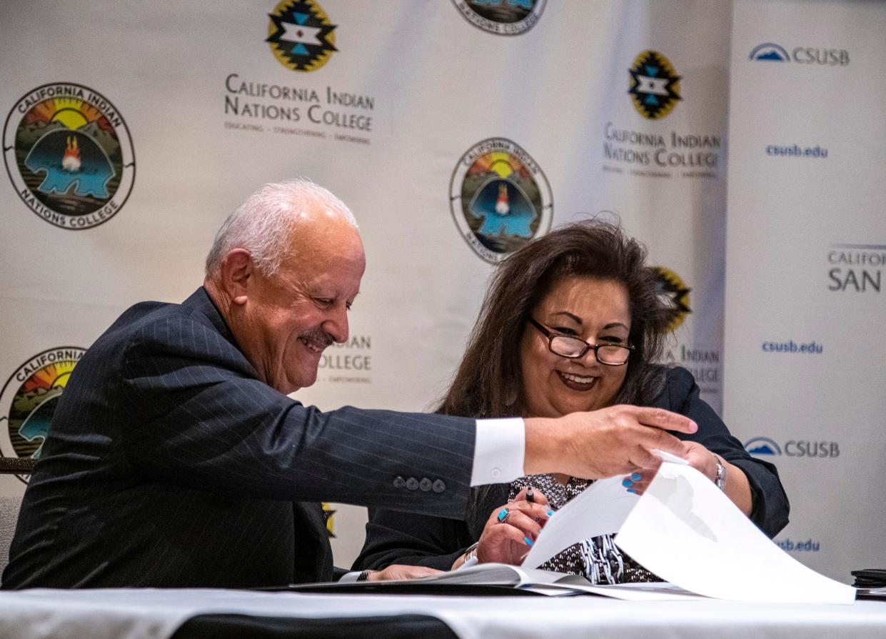 California State University, San Bernardino President Tomás Morales and California Indian Nations College President Celeste Townsend smile while signing a memorandum of understanding agreement to increase the number of Native American transfer students to the CSUSB campus during a ceremony at Classic Club in Palm Desert, Calif., Tuesday, Oct. 4, 2022.