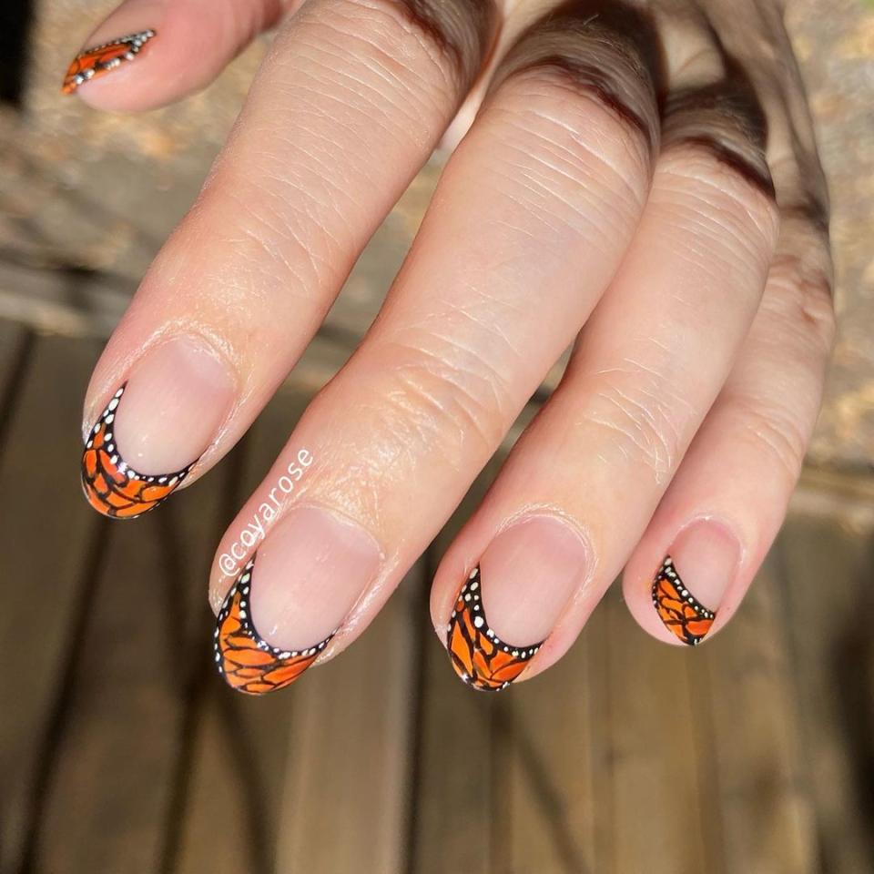 Butterflies are never <em>not</em> having moment, and this monarch-meets-French mani is sure to make your heart flutter.