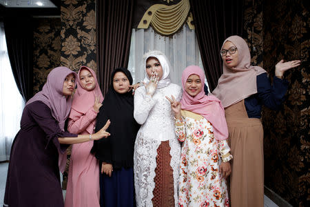 A wedding photo of the bride of a Lion Air flight JT610 victim, who carried on the celebration despite the absence of the groom, in Bangka, Bangka Belitong Province, Indonesia November 11, 2018 in this picture obtained from social media on November 16, 2018. LALA INDRA PERMANA/via REUTERS THIS IMAGE HAS BEEN SUPPLIED BY A THIRD PARTY. MANDATORY CREDIT. NO RESALES. NO ARCHIVES.