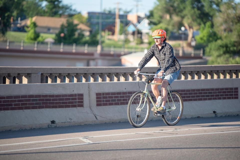 James Wyatt rides across the Union Avenue bridge as part of Bike to Work Day on Wednesday, June 28, 2023.