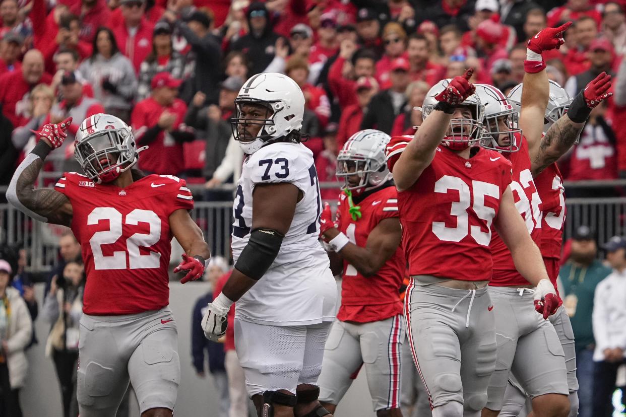 Oct 21, 2023; Columbus, Ohio, USA; Ohio State Buckeyes linebacker Steele Chambers (22), linebacker Tommy Eichenberg (35) and teammates celebrate a false start by Penn State Nittany Lions offensive lineman Caedan Wallace (73) during the NCAA football game at Ohio Stadium.