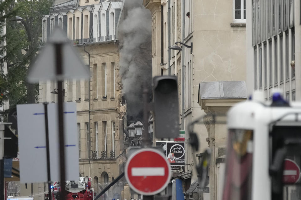 Smoke billows from a building as firemen fight a blaze Wednesday, June 21, 2023 in Paris. Firefighters fought a blaze on Paris' Left Bank that is sent smoke soaring over the domed Pantheon monument and prompted evacuation of buildings in the neighborhood, police said. Local media cited witnesses describing a large explosion preceding the fire, and saying that part of a building collapsed. (AP Photo/Christophe Ena)