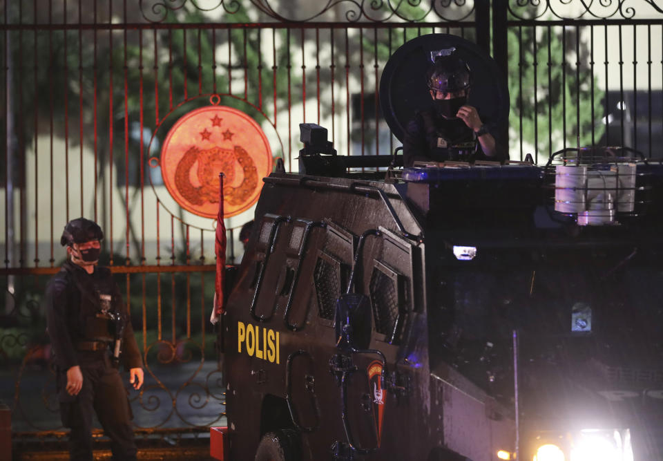 An officer mans his position at an armored vehicle parked at the National Police Headquarters following a suspected militant attack in Jakarta, Indonesia, Wednesday, March 31, 2021. A woman entered the Indonesian National Police Headquarters in Jakarta and pointed a gun at several officers before being shot dead by police, in the latest in a series of militant attacks in the world's most populous Muslim nation. (AP Photo/Dita Alangkara)