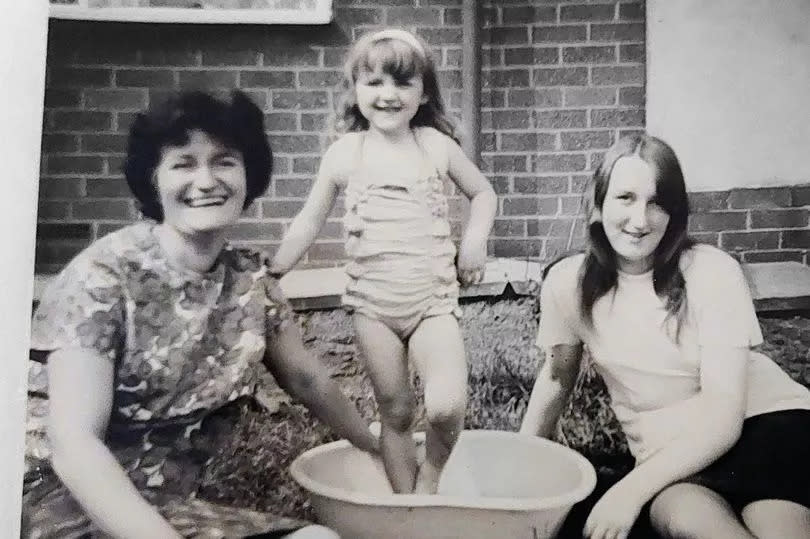 Maria Murphy (right) aged 15, her mum Sally and sister Michelle, aged four, in the garden of their house on Braemar Grove, Darnhill in 1967